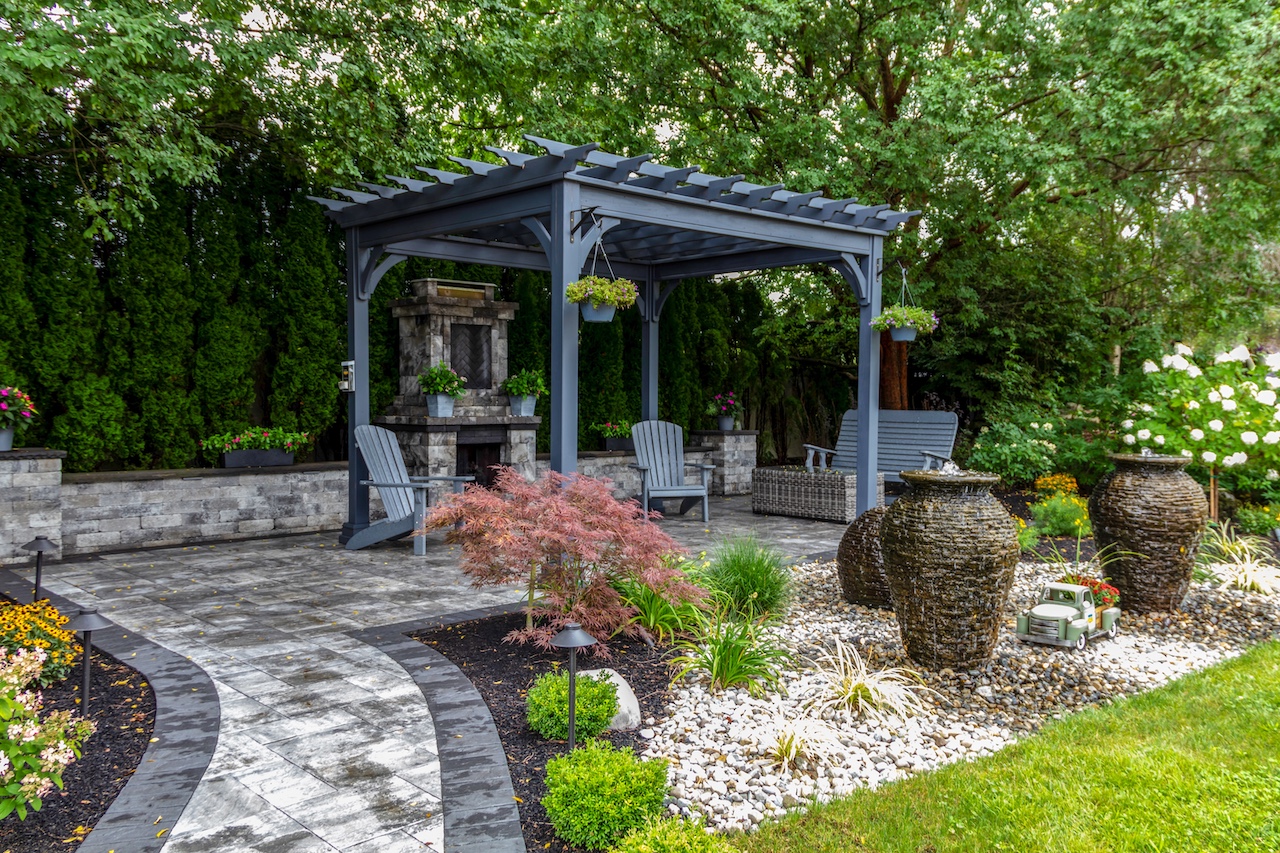 Pergola and patio design with landscape lighting by Total Care Montana