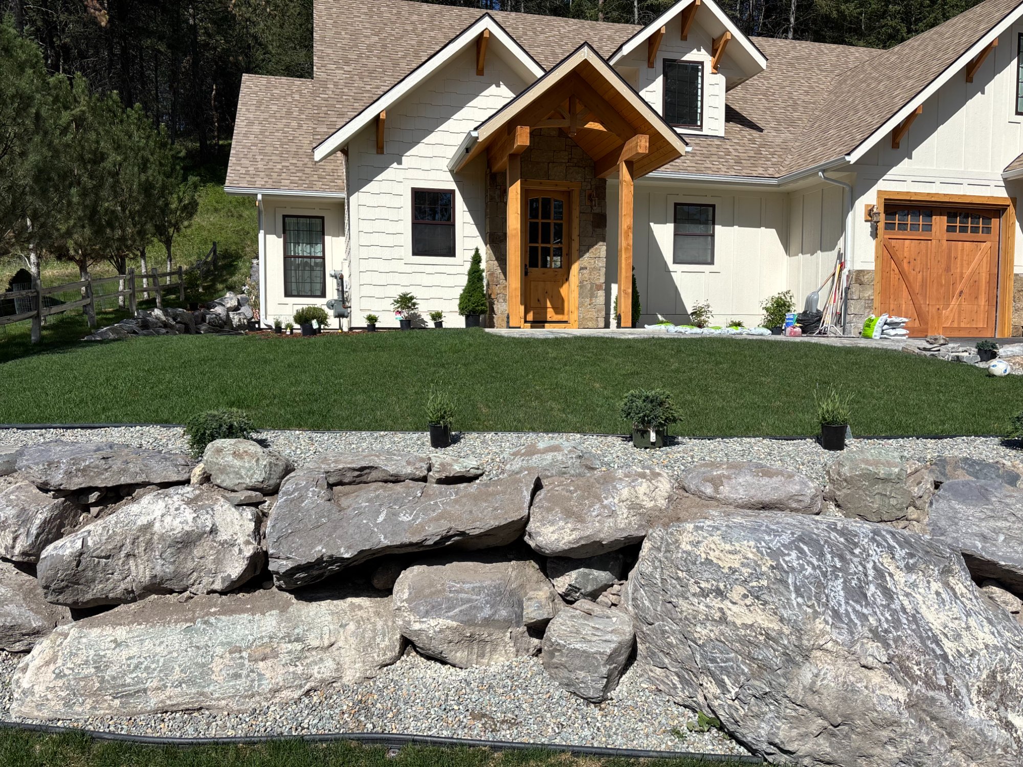 Rock and boulder landscape installation in Kalispell Montana by Total Care Montana